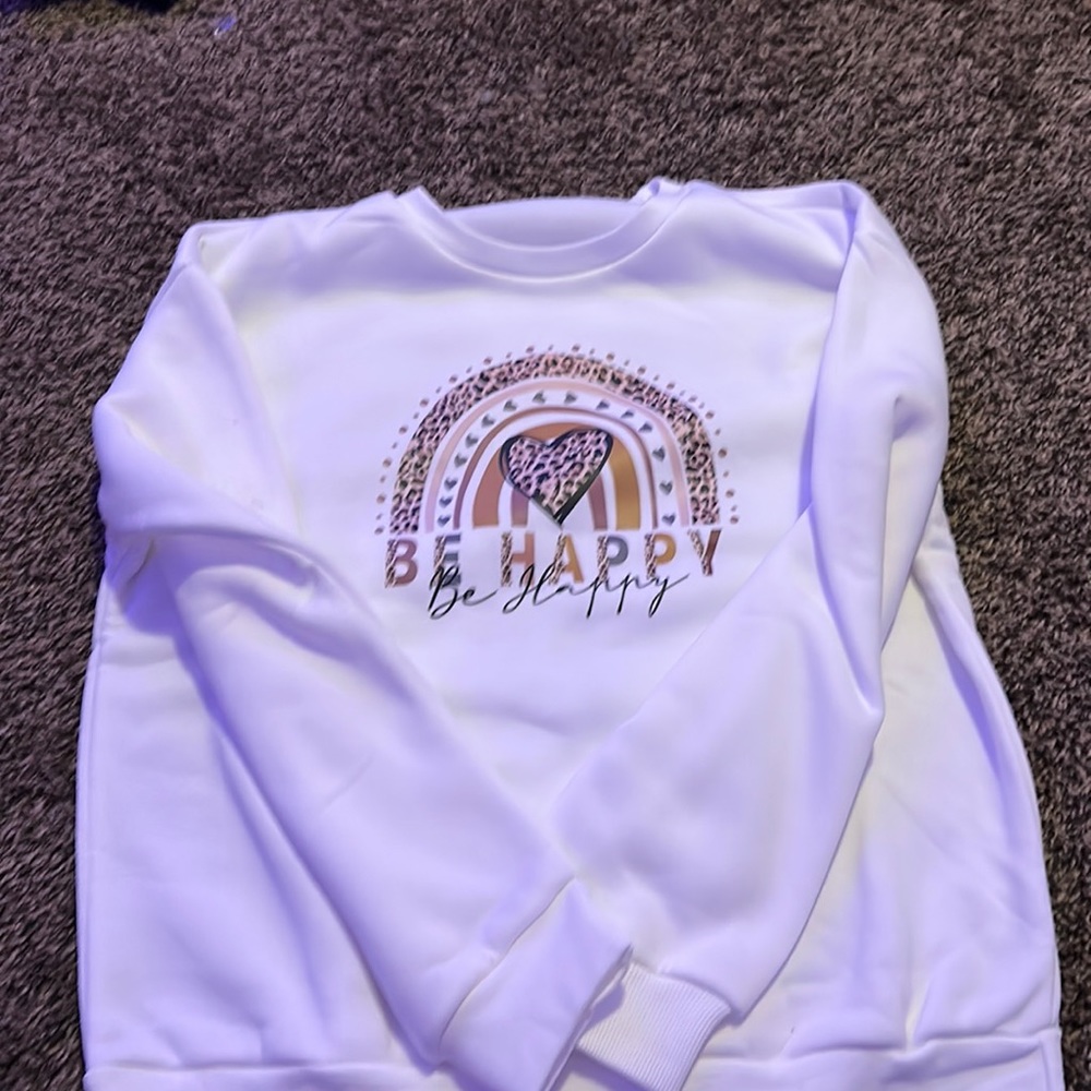 white “be happy” sweatshirt